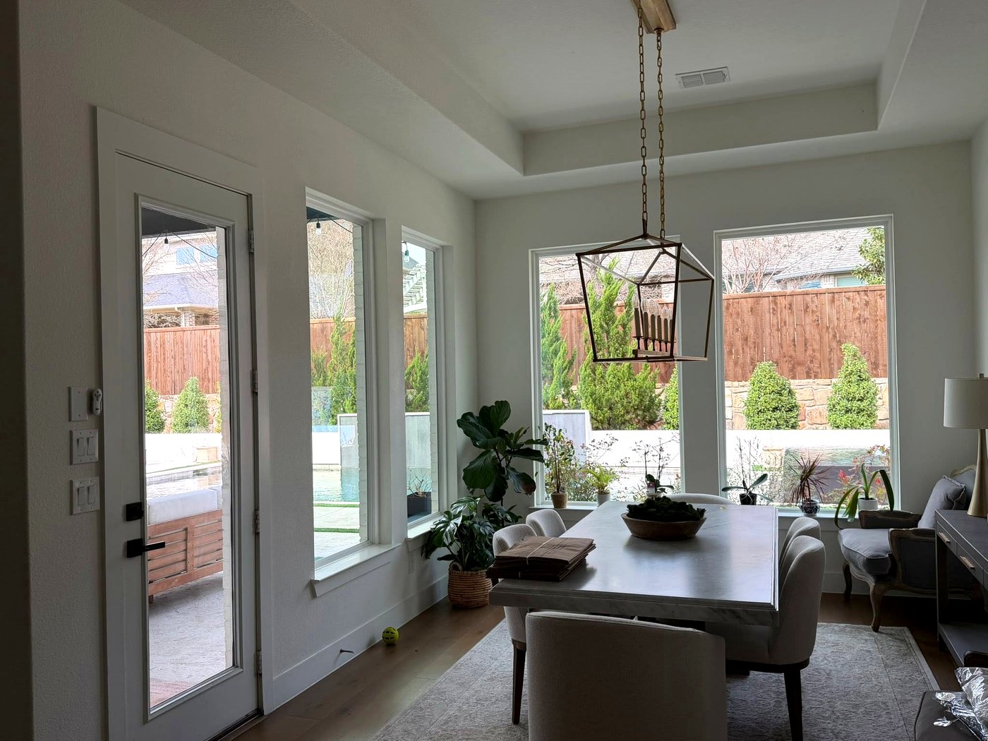 Spotless interior windows in a bright North Texas dining room looking onto the backyard